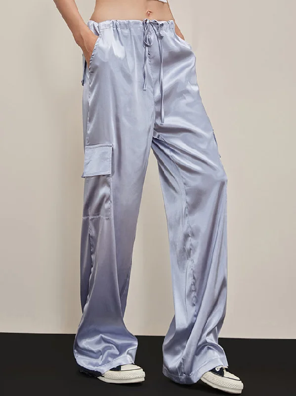 Flared trousers – Trousers with a gradual flare from the knee down, often associated with retro or 1970s fashion.BerryBetty - Oversized Pockets Satin Parachute Pants