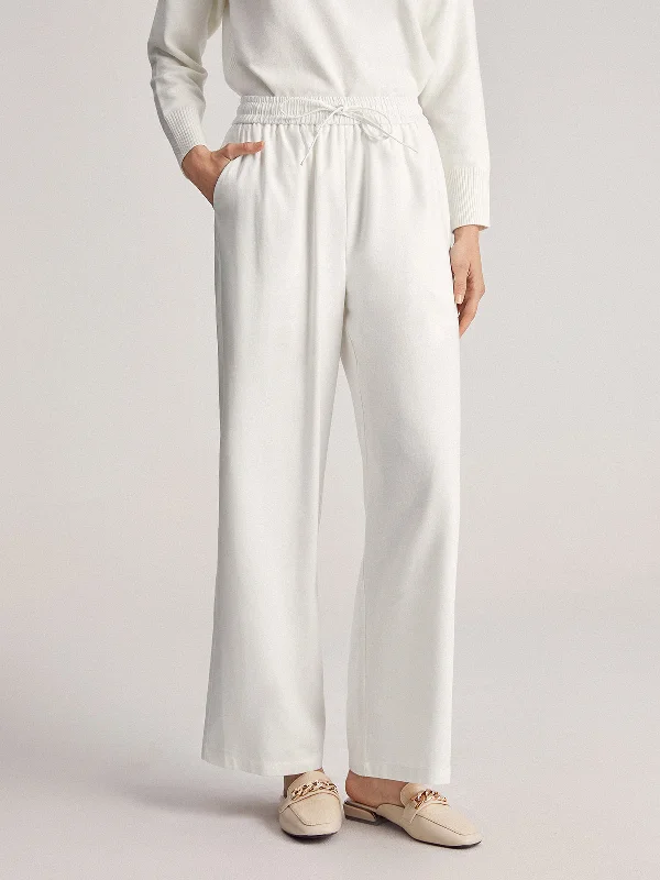 Flared trousers – Trousers with a gradual flare from the knee down, often associated with retro or 1970s fashion.BerryBetty - Simple Bell Drawstring Wide Leg Pants