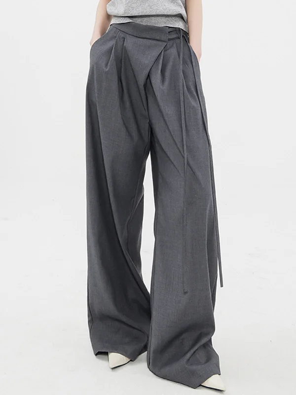 Pleated trousers – Trousers with folds or pleats in the front, often adding volume or texture to the garment.BerryBetty - Tied Oversized Wide Leg Pants