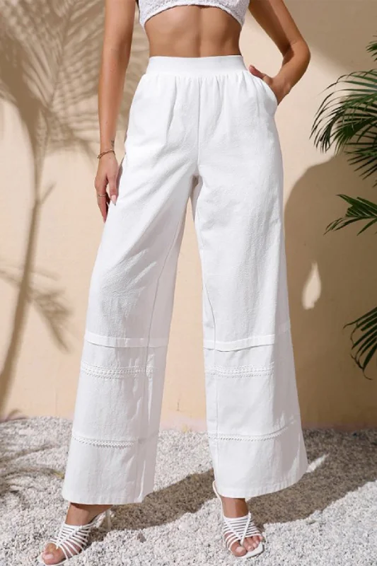 Palazzo trousers – Wide-leg trousers made from light, flowy fabric, often associated with a chic or bohemian look.BerryBetty - White Embossing Wide Leg Pants