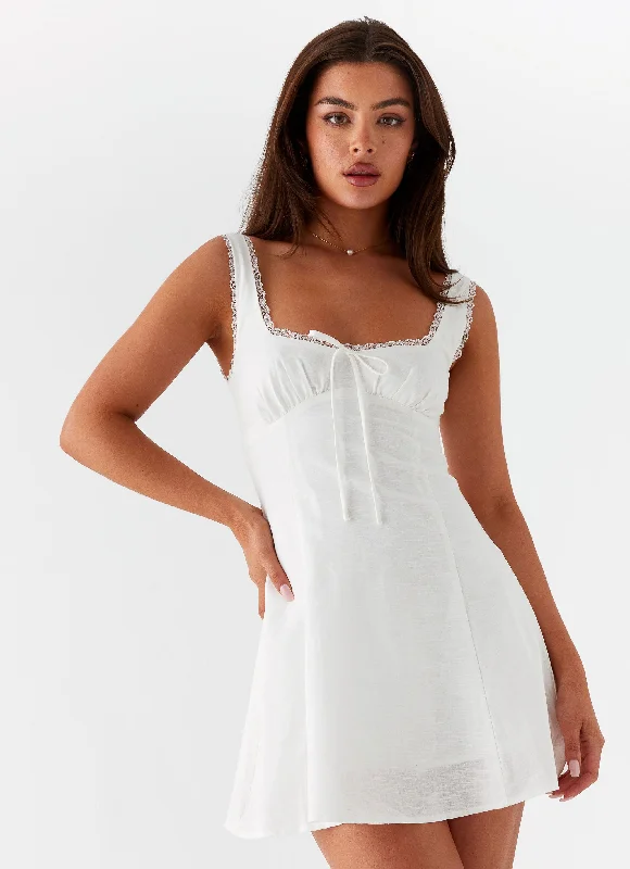 Asymmetrical skirt – Skirt with an uneven or diagonal hemline for a modern and unique appearance.Rowena Mini Dress - White