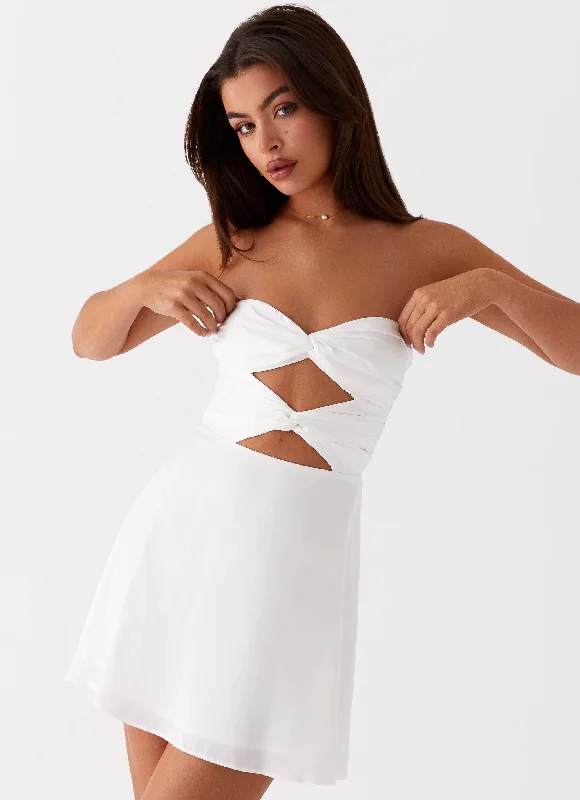 Asymmetrical skirt – Skirt with an uneven or diagonal hemline for a modern and unique appearance.Taga Twist Mini Dress - White