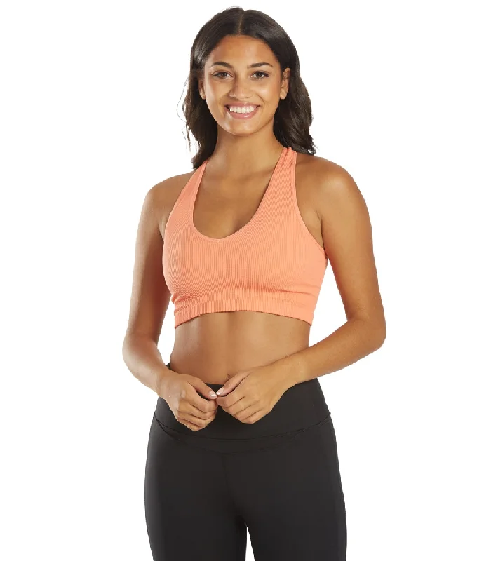 Compression sports bra – Sports bra that compresses the chest for a more secure fit and reduced bounce during high-impact activities.Free People Free Throw Yoga Crop Coral Reef