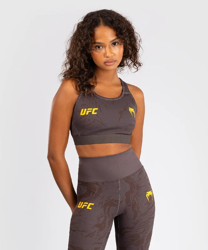 Front-closure sports bra – Sports bra that fastens at the front, often with hooks, zippers, or snaps, for easier wear.UFC Fusion by Venum Fight Week Women’s Sports Bra - Earthen Brown